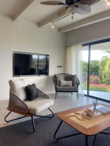 a living room with a couch and a table at Beachside Residence in Koh Samui 