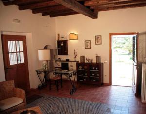 a living room with a desk and a table at Maragani Beach in Maragani