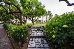 a picnic table in a park with flowers and trees at Villa Irlanda Grand Hotel in Gaeta