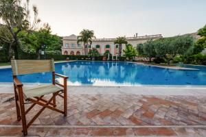 a chair sitting in front of a swimming pool at Villa Irlanda Grand Hotel in Gaeta