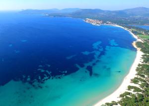 een luchtzicht op een strand en de oceaan bij Hotel Oasis in Alghero