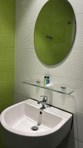 a bathroom with a sink and a mirror at Mizie Hotel Kuala Lumpur in Kuala Lumpur +40 photos