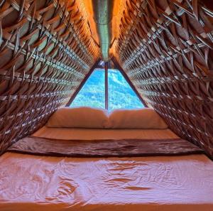 a view of a window in a hammock tent at GAïA Cabinhouse in Cebu City