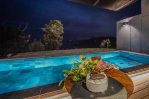 a cake on a table next to a swimming pool at Oyado The Earth in Toba