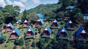 an aerial view of a group of houses on a hill at อุกฤษฟาร์มฮิลล์ ภูชี้ฟ้า Ukrist farm hill in Thoeng