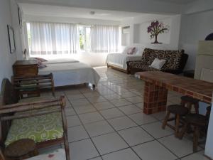 a living room with a bed and a couch at Hotel Oasis Cuyutlan in Cuyutlán