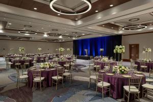 a ballroom with tables and chairs with purple tablecloths at The Westin Houston, Memorial City in Houston +134 photos
