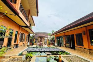 a courtyard with a pond in the middle of a building at Vela House Phuket in Changwat Phuket