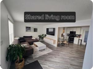 a living room with a couch and a table at Cozy in Regina
