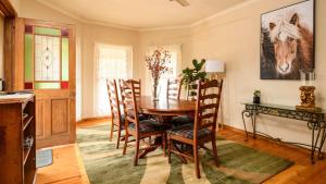 a dining room with a wooden table and chairs at Honeycomb Lodge in Daylesford