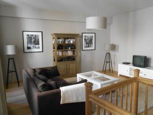 a living room with a couch and a table at Maison De Charme En Bourgogne in Saint-Gengoux-le-National