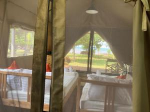 a room with two beds and a window at Naivacha Tent Koh Mak in Ko Mak