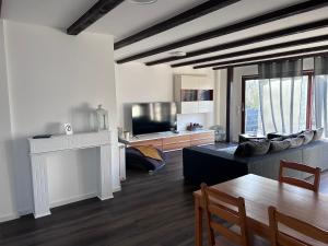 a living room with a couch and a table at schönes Apartment mit Dachterrasse in Oldenburg