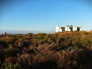 a white house on the top of a hill at The Daiquiri Shaq in St Helena Bay