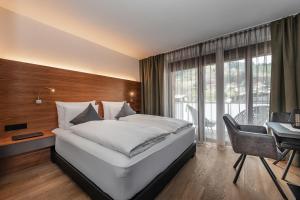 Postel nebo postele na pokoji v ubytování AlpenParks Hotel & Apartment Taxacher + 37 fotografií