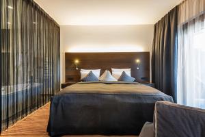 Voodi või voodid majutusasutuse AlpenParks Hotel & Apartment Taxacher toas