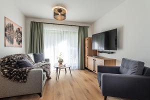 Televiisor ja/või meelelahutuskeskus majutusasutuses AlpenParks Hotel & Apartment Taxacher