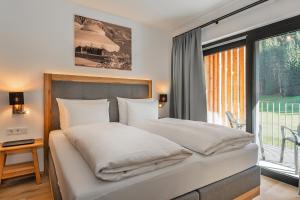 Voodi või voodid majutusasutuse AlpenParks Hotel & Apartment Taxacher toas