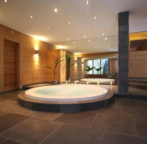 a large pool in the middle of a room at Helvetia hotel in Morgins