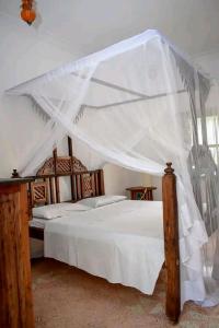 Postel nebo postele na pokoji v ubytování Mlima cottage