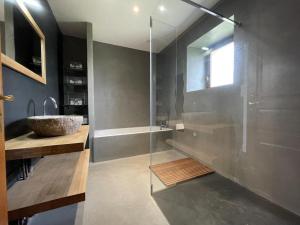 a bathroom with a shower and a sink and a tub at Etxola in Saint-Jean-Pied-de-Port +9 photos