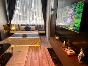 a room with two beds and a flat screen tv at Spring Home in Can Tho