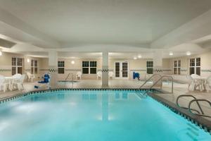 a pool in a hotel with chairs and tables at Country Inn & Suites by Radisson, Boise West - Meridian in Meridian