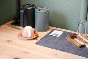 a table with a trash can and a hat on it at Kreilingshöfchen Apartments in Bad Vilbel