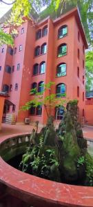 a building with a fountain in front of a building at Kaibu Courtyard Superior Apartment, Changjiang Cable Car Nanbin Road, Chongqing in Chongqing