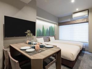 a bedroom with a dining table and a bed at Minn Kiyomizu Gojo in Kyoto