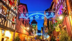 a city street at night with christmas lights at Le Gîte de Jade in Dannemarie