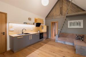 a kitchen with a sink and a counter top at Pilnikárna in České Křižánky