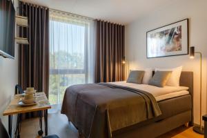 Postel nebo postele na pokoji v ubytování Hessnery Hotel