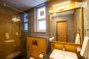 a bathroom with a sink and a mirror at StayVista at Grove - Elysium Estate with Hill View, Lawn in Shimla +10 photos