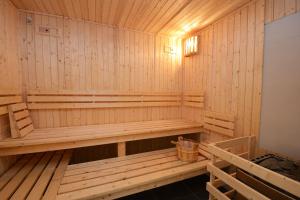 a wooden sauna with a bench in it at Résidence Odalys Les Balcons d'Auréa in Auris