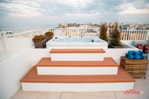 a hot tub on the balcony of a building at Spinola Stays in St. Julianʼs