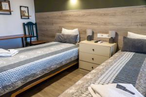 two beds sitting next to each other in a bedroom at Guest House Malusha in Gabrovo