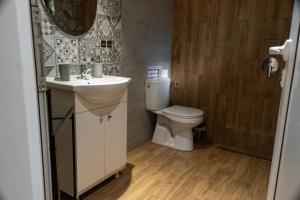 a bathroom with a sink and a toilet at Guest House Malusha in Gabrovo