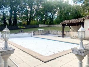 a swimming pool in a backyard with two lights at Chez Mike in Montdoumerc
