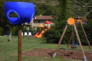 a playground with a blue bucket on a pole at Villa Gradoni in Monticelli Brusati