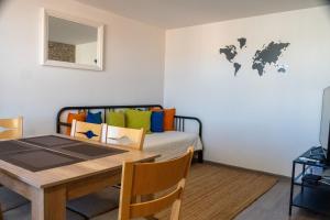 a dining room with a table and a bed at Guest House Malusha in Gabrovo