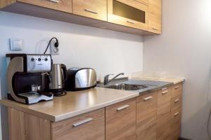 a kitchen with a sink and a counter top at Guest House Malusha in Gabrovo