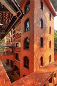 a red brick building with a lot of windows at Kaibu Courtyard Superior Apartment, Changjiang Cable Car Nanbin Road, Chongqing in Chongqing