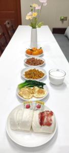 a table with four plates of food on it at Kaibu Courtyard Superior Apartment, Changjiang Cable Car Nanbin Road, Chongqing in Chongqing