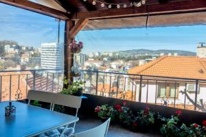 a room with a table and a view of a city at Guest House Malusha in Gabrovo