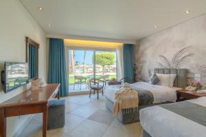 A bed or beds in a room at Three Corners Sea Beach Resort