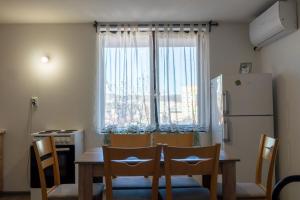 a kitchen with a table and chairs and a refrigerator at Guest House Malusha in Gabrovo