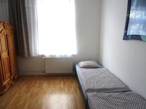 En eller flere senge i et værelse på Apartment Haus Essen + 1 billede