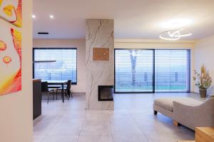 a living room with a couch and a fireplace at Villa Rose close to Vienna & Airport in Maria Ellend