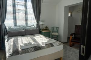 a bedroom with a bed with two towels on it at Guest House Malusha in Gabrovo